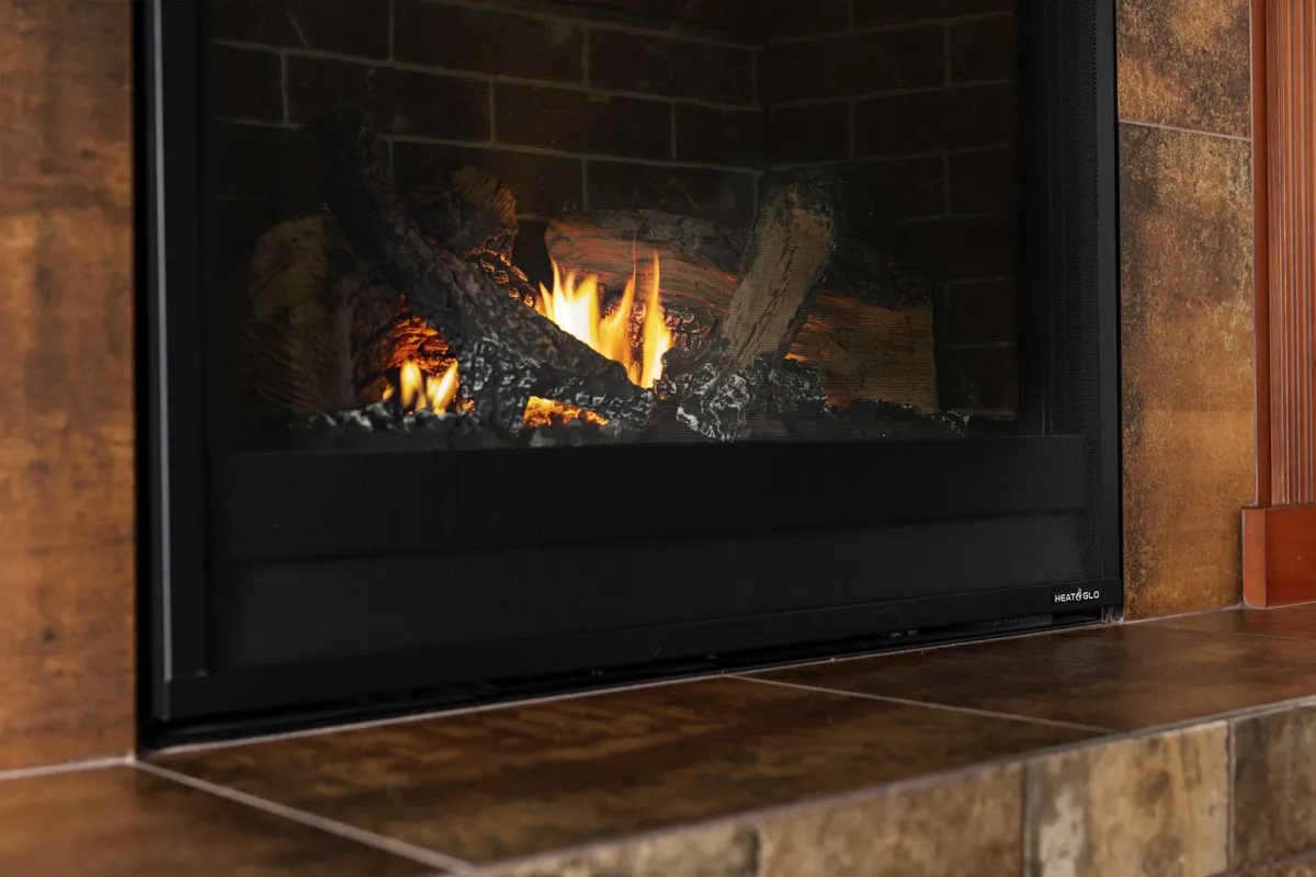 A cozy fireplace with glowing flames and rustic logs, creating a warm ambiance that invites guests to relax, socialize, and share stories. The scene evokes comfort, making it well-suited for gatherings during cooler seasons or celebratory evenings.